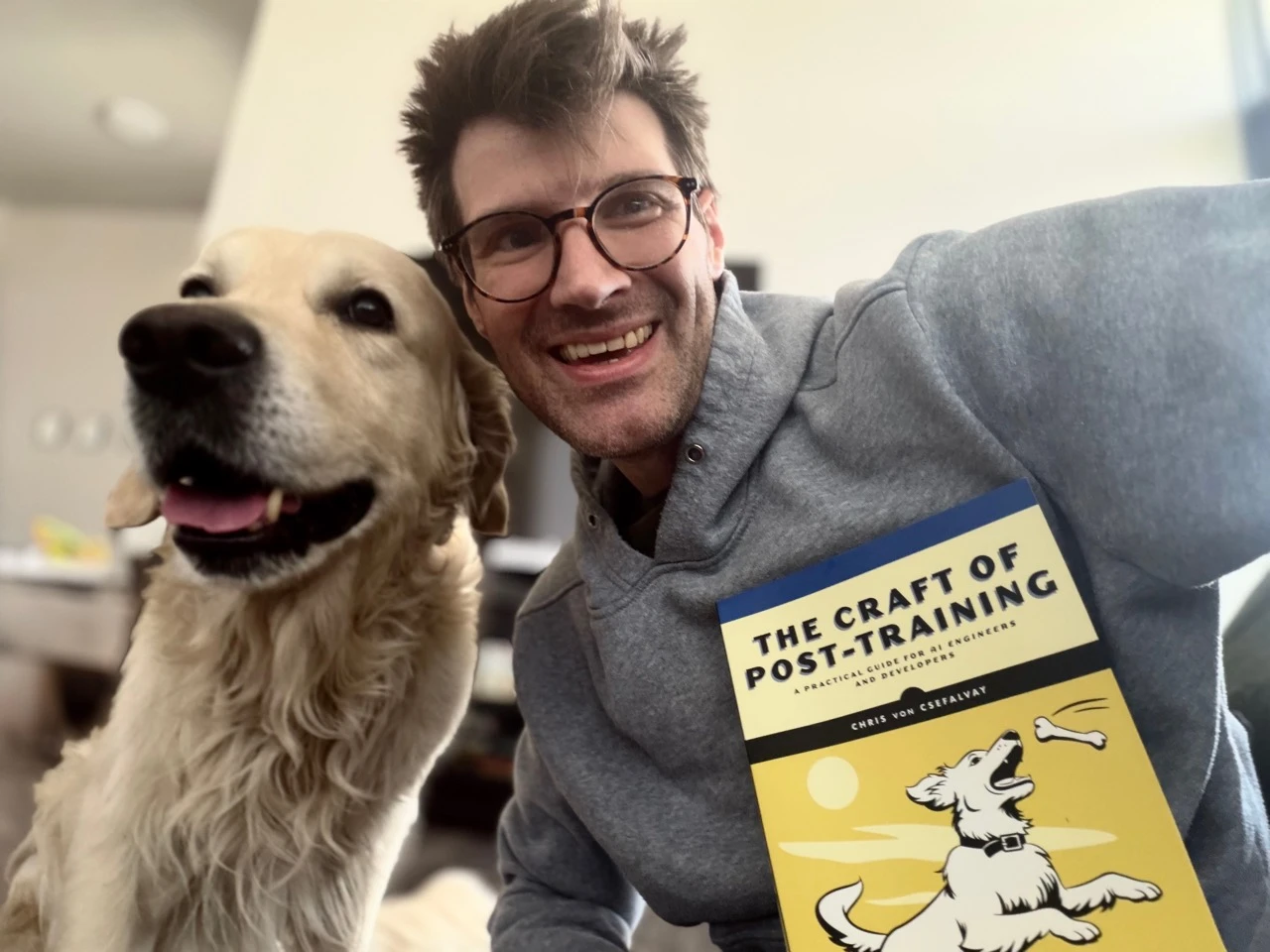 Chris von Csefalvay with his dog and a copy of The Craft of Post-Training.